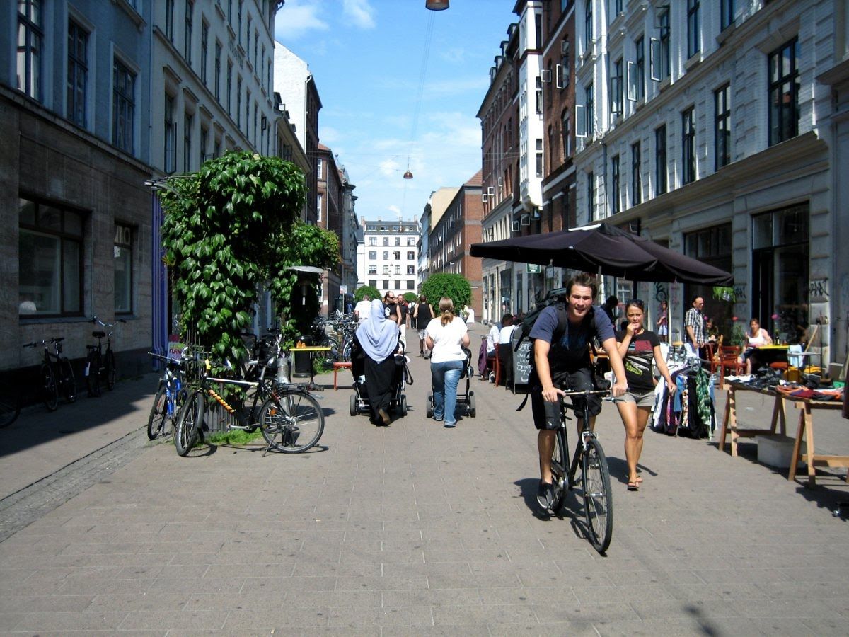 People walking, cycling and pushing buggies in the middle of a road